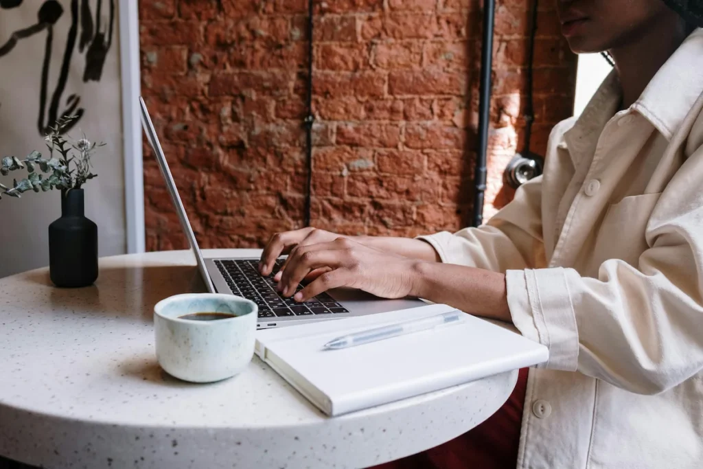 Girl typing on a laptop, capturing her ideas as part of her daily writing routine.