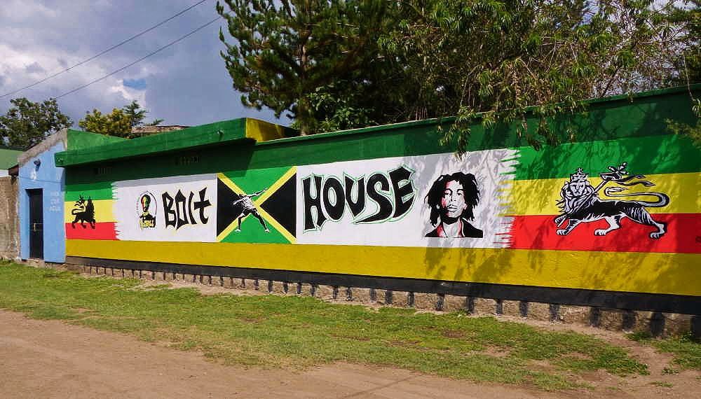 Outside wall of Bolthouse, a restaurant in Shashemene. It is painted with the old Ethiopian flag and the Jamaican flag, creating a colorful and vibrant display where visitors stopped briefly for refreshments.